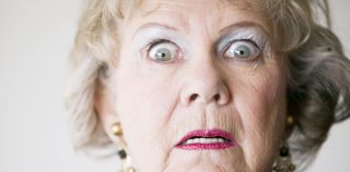 Close-up of a senior woman with a horrified look on her face. 1899 Hoffenheim vs. Bayern München